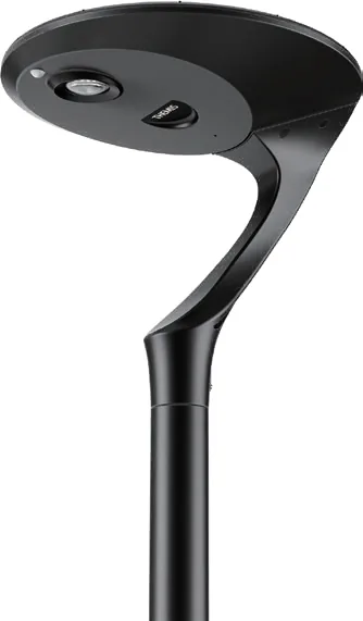 A black modern outdoor post light with a curved neck and a flat, circular head featuring a downward-facing lens and a small sensor.